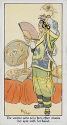 Die Frau, die Fächer verkauft, schattet oft ihre Augen mit der Hand